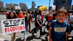Hundreds of students walk out of school to rally against gun violence, April 20, 2018, in downtown Los Angeles. Protests were held across the country Friday, on the 19th anniversary of the Columbine High School shooting.