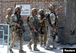 FILE - Afghan security forces arrive at the site of a suicide attack in Kabul, Afghanistan, March 21, 2018.