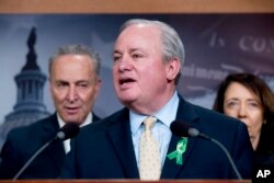 Rep. Mike Doyle, D-Pa., center, accompanied by Senate Minority Leader Sen. Chuck Schumer of N.Y., left, and Sen. Maria Cantwell, D-Wash., speaks at a news conference about net neutrality in Washington, May 16, 2018.