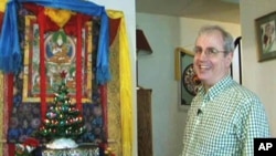 Wilson Hurley has put up a Christmas tree in his house in front of an image of Buddha