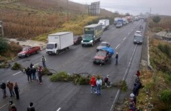 Indigenous people block a road in Santa Catarina Ixtahuacan, Guatemala on Dec. 21, 2021.