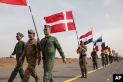 Flag bearers carry flags representing different countries taking part in the opening ceremony of Flintlock, anti-terrorism training in Thies, Senegal, Feb. 8, 2016.