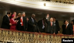 Cuba's President Raul Castro waves to the audience as he takes his seat near Cuba's prima ballerina, Alicia Alonso, second left, before U.S. President Barack Obama speaks at the Gran Teatro, in Havana, Cuba, March 22, 2016.