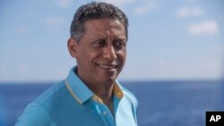 Seychelles President Danny Faure smiles during an interview with the Associated Press, on board the vessel Ocean Zephyr off the coast of Desroches, in the outer islands of Seychelles, April 13, 2019.