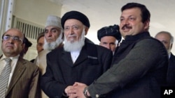 Pakistan's Minister of State of Foreign Affairs Nawabzada Malik Amad Khan (r) shakes hands with former Afghan President and chief of a new peace council Burhanuddin Rabbani before their meeting at the Foreign Ministry in Islamabad, 05 Jan 2011