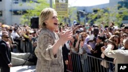 FILE - Democratic presidential candidate Hillary Clinton speaks to people in the overflow area during a campaign event at Los Angeles Southwest College in Los Angeles, April 16, 2016. Despite a formidable challenge from Senator Bernie Sanders, Clinton is likely to clinch the nomination June 7.