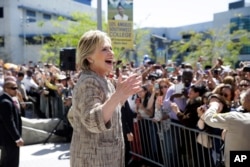 FILE - Democratic presidential candidate Hillary Clinton speaks to people in the overflow area during a campaign event at Los Angeles Southwest College in Los Angeles, April 16, 2016.