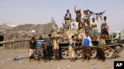 Tribal fighters loyal to the Yemeni government stand by a tank in al-Faza area near Hodeida, Yemen June 1, 2018. 
