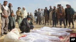 Afghan villagers gather around several victims' bodies who were killed during clashes between Taliban and Afghan security forces in Taliban's controlled village, Buz-e Kandahari village in Kunduz province, north of Kabul, Afghanistan, Friday, Nov. 4, 2016.