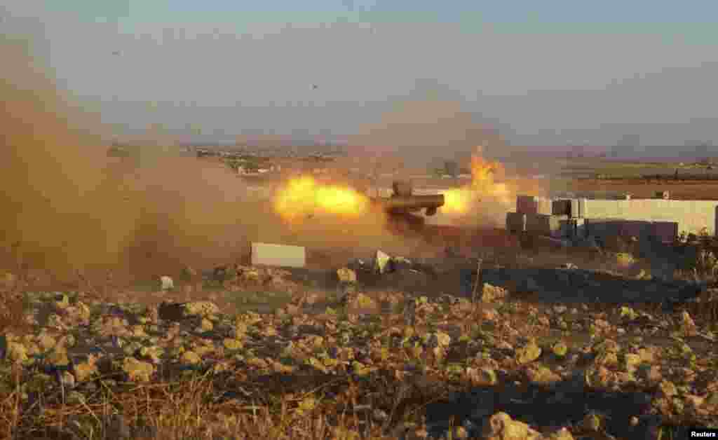 Free Syrian Army fighters fire anti-tank missiles during what they said were clashes with forces loyal to Syria's President Bashar al-Assad in the eastern Hama countryside, Oct. 14, 2013.