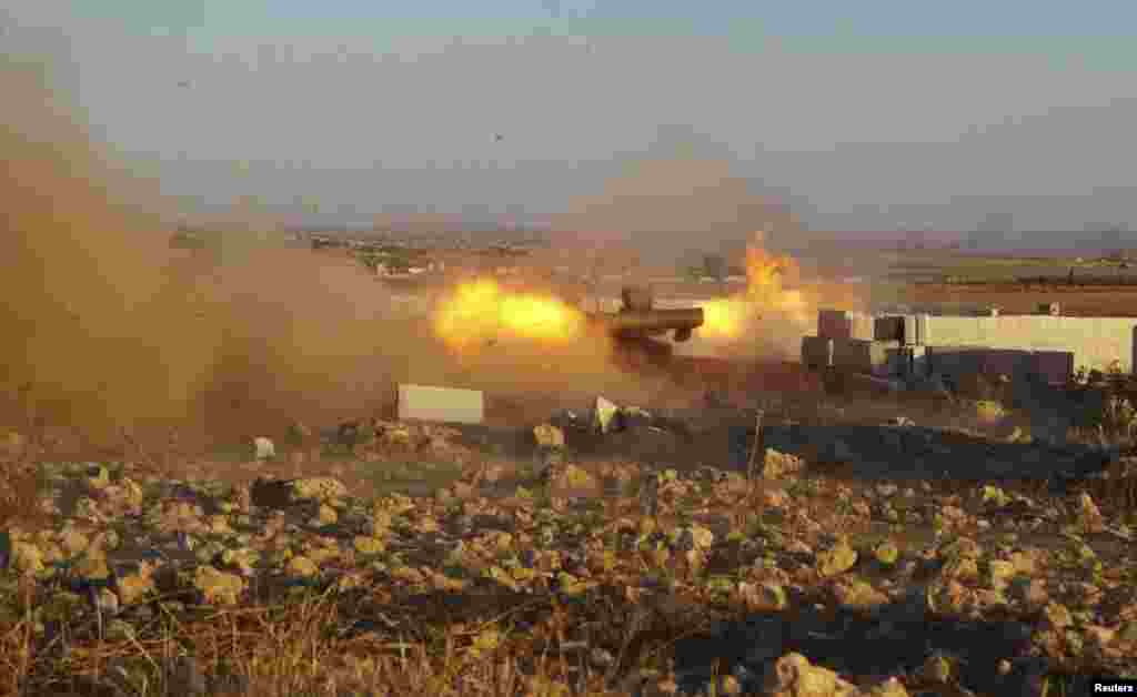 Free Syrian Army fighters fire anti-tank missiles during what they said were clashes with forces loyal to Syria's President Bashar al-Assad in the eastern Hama countryside, Oct. 14, 2013. 