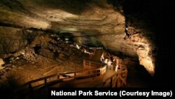Visitors explore the cave