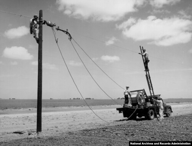 The Rural Electrification Administration (REA) erects telephone lines in rural areas. (date unknown)