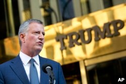 FILE -New York Mayor Bill de Blasio holds a news conference in front of Trump Tower following a meeting with President-elect Donald Trump, Nov. 16, 2016, in New York.