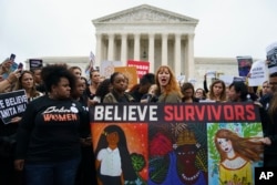 Protesters with Women's March and others gather in front of the Supreme Court on Capitol Hill in Washington, Sept. 24, 2018.