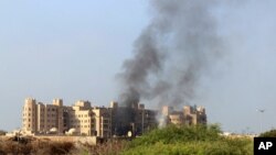 Smoke rises following an explosion that hit Hotel al-Qasr where Cabinet members and other government officials are staying, in the southern port city of Aden, Yemen, Oct. 6, 2015.