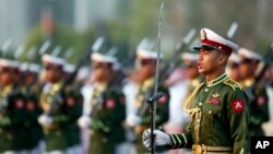 FILE - Myanmar soldiers parade during a ceremony to mark the 69th anniversary of Union Day in Naypyitaw, Myanmar. Kyaw Swa Naing and editor Kyaw Min Swe were arrested in June after a military officer filed a complaint against them. 