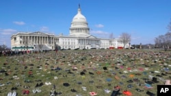 7000 pairs of shoes, one for every child killed by gun violence since the Sandy Hook school shooting, were placed on the Capitol lawn by Avaaz, a U.S.-based civic organization, on Capitol Hill in Washington, Tuesday, March 13, 2018.