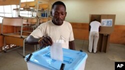 A man casts his ballot at a voting station in Kicolo, Luanda, Angola, August 31, 2012.