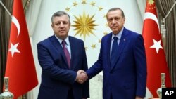 Turkey's President Recep Tayyip Erdogan, right, shakes hands with Georgian Prime Minister Giorgi Kvirikashvili after having returned to the nation's capital for the first time since an attempted coup in the country, at the Presidential palace in Ankara, Turkey on July 19, 2016.