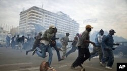 Anti-government protestors run from tear gas in Senegal's capital Dakar, February 15, 2012.