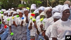 FILE- Liberia women walk, after praying for help with the Ebola virus, in the city of Monrovia, Liberia, Aug. 14, 2014.