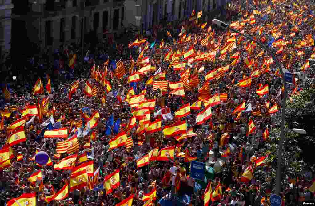 A pro-union demonstration organized by the Catalan Civil Society makes its way through the streets of Barcelona, Spain.