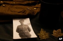 A photo, badge and uniform of a Canadian World War I soldier are on display in a presentation case at Hooge Crater Museum in Ypres on Nov. 4, 2021.