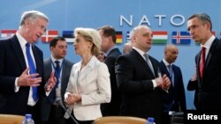 From left, Britain's Defense Secretary Michael Fallon, German Defense Minister Ursula von der Leyen, Georgia's Defense Minister Mindia Janelidze and NATO Secretary-General Jens Stoltenberg attend a meeting at the Alliance headquarters in Brussels, Feb. 5, 2015.