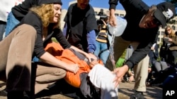 FILE - Protesters simulate the use of waterboarding on a volunteer at an anti-torture rally in front of the Justice Department in Washington, Nov. 5, 2007.