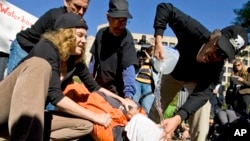 Protesters simulate the use of waterboarding on a volunteer at an anti-torture rally in front of the Justice Department in Washington, Nov. 5, 2007.