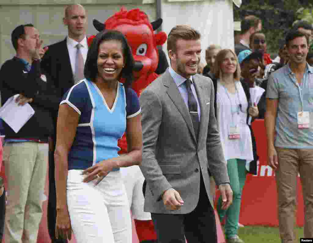 Đệ nhất phu nh&acirc;n Mỹ Michelle Obama đứng cạnh cầu thủ b&oacute;ng đ&aacute; người Anh David Beckham trong một sự kiện tại đại sứ qu&aacute;n Mỹ ở trung t&acirc;m London, 27 th&aacute;ng 7, 2012.