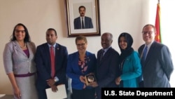 FILE - From left are Chief of Mission Natalie E. Brown, Rep. Joe Neguse, Rep. Karen Bass, Minister of Foreign Affairs Osman Saleh, Rep. Ilhan Omar and Deputy Chief of Mission Stephen Banks. Members of Congress were the first to visit Eritrea in 14 years.