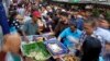 Office workers shop for "iftar," the meal to break their fast on the first day of the holy fasting month of Ramadan, at the main business district in Jakarta, Indonesia, June 18, 2015.