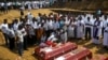 People react during a mass burial of victims, two days after a string of suicide bomb attacks on churches and luxury hotels across the island on Easter Sunday, at a cemetery near St. Sebastian Church in Negombo, Sri Lanka, April 23, 2019.