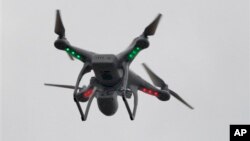 FILE - A drone hovers over the scene of an explosion that leveled two apartment buildings in the East Harlem neighborhood of New York, New York, March 12, 2014.