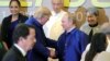 U.S. President Donald Trump and Russian President Vladimir Putin shake hands as they take part in a family photo at the APEC summit in Danang, Vietnam, Nov. 10, 2017.