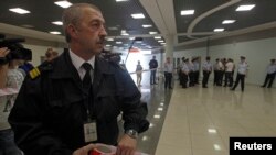 Russian airport security staff secure an area after former U.S. spy agency contractor Edward Snowden was granted documents that will allow him to leave the transit area of Sheremetyevo airport in Moscow, July 24, 2013. 