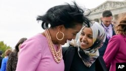 FILE - U.S. Reps. Jahana Hayes, D-CT., left, and IIhan Omar, D-Minn., right, walk together after taking a group photo with other members of the freshman class of Congress on Capitol Hill in Washington. 