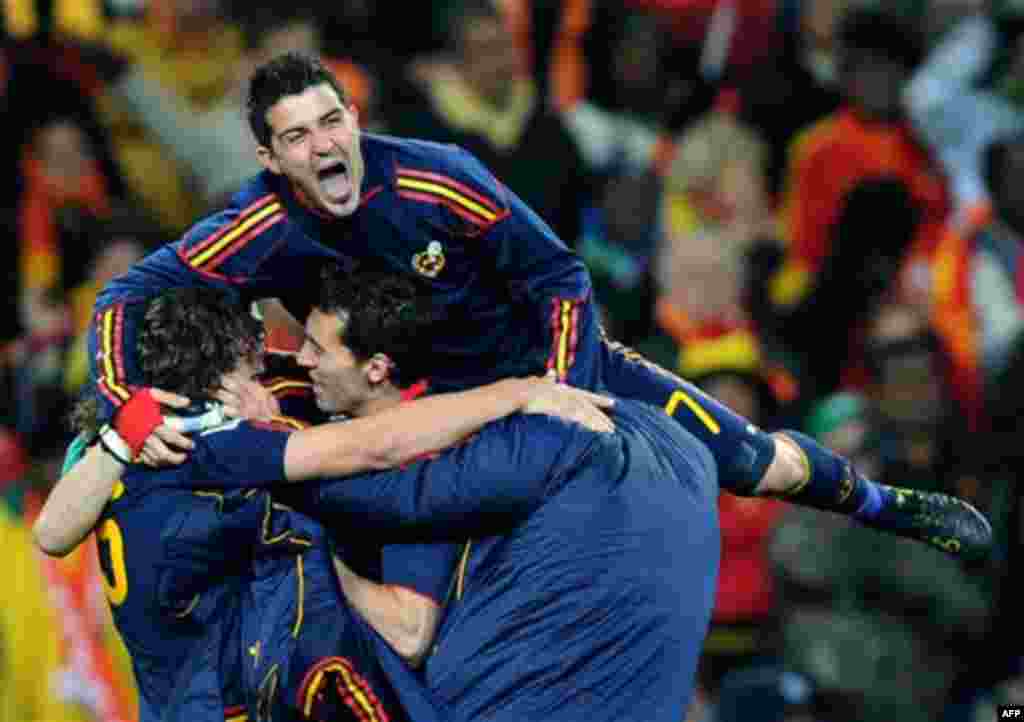 Spain's David Villa, top, celebrates with teammates at the end of the World Cup final soccer match between the Netherlands and Spain at Soccer City in Johannesburg, South Africa, Sunday, July 11, 2010. Spain won 1-0.(AP Photo/Daniel Ochoa de Olza)