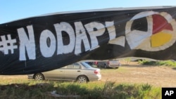 A banner protesting the Dakota Access oil pipeline is displayed at an encampment near North Dakota's Standing Rock Sioux reservation, Sept. 9, 2016. 