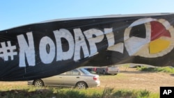 A banner protesting the Dakota Access oil pipeline is displayed at an encampment near North Dakota's Standing Rock Sioux reservation, Sept. 9, 2016. 