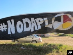 A banner protesting the Dakota Access oil pipeline is displayed at an encampment near North Dakota's Standing Rock Sioux reservation, Sept. 9, 2016.