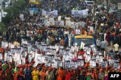 Supporters of Bangladesh Awami League march along a street as they take part in a rally ahead of Dec. 30 general election vote, in Dhaka, Dec. 27, 2018.