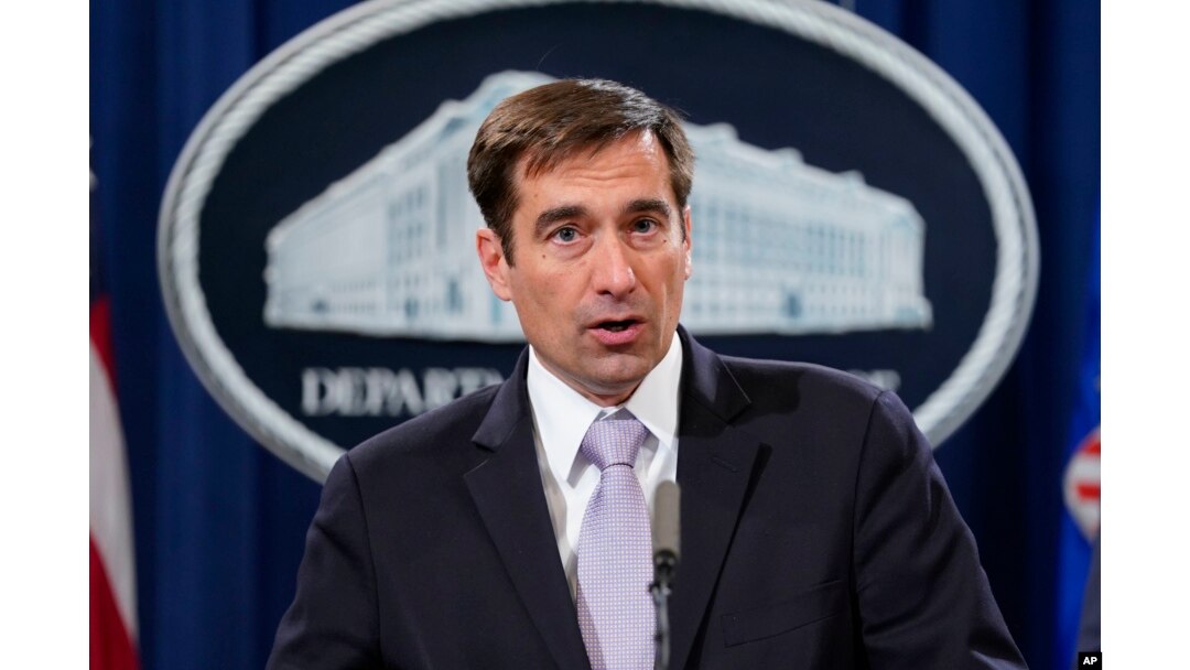 Assistant Attorney General for National Security John Demers speaks during a news conference to announce a criminal law enforcement action involving China, at the Department of Justice in Washington, Nov. 1, 2018.
