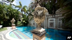 Decorative artwork stands in front of the 55-foot long swimming pool at the Versace mansion in Miami Beach, Fl., July 23, 2013.