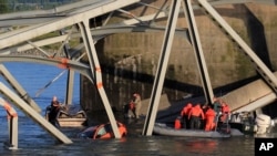 In this photo provided by Francisco Rodriguez, rescue boats approach victims at their vehicles in the Skagit River after the collapse of the Interstate 5 bridge in Mount Vernon, Wash., May 23, 2013.