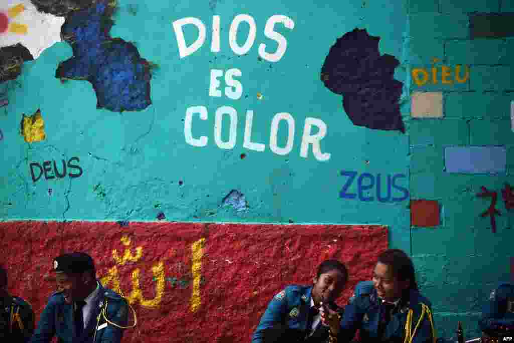 Students rest before taking part in a parade to commemorate the 114th anniversary of Panama&#39;s independence from Colombia, in Panama City, Panama.