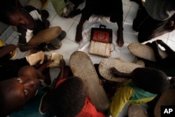 FILE - Koranic students memorize verses in the school where they live and study, in Dakar, Senegal, Aug. 31, 2010.
