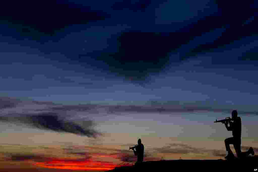 Metal placards in the shape of Israeli soldiers stand on an old bunker during sunset at an observation point on Mt. Bental in the Israeli controlled Golan Heights, overlooking the border with Syria.